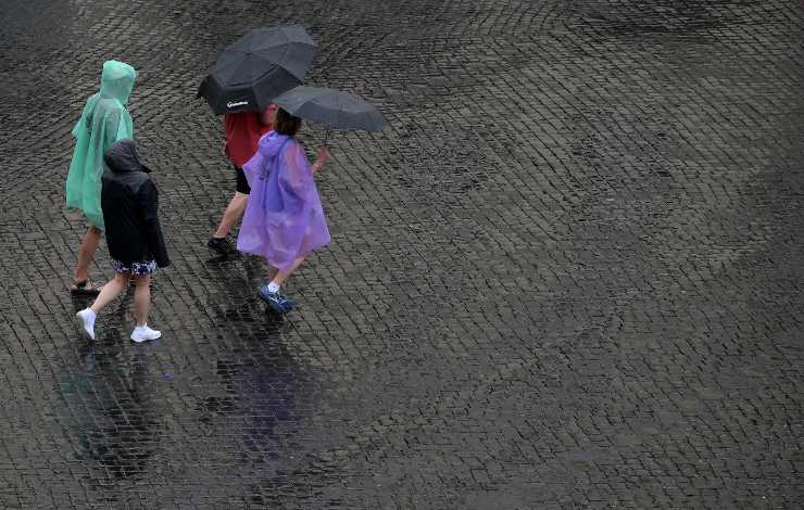 Passanti con ombrelli durante un temporale a Roma, dove nel weekend è previsto maltempo (Immagine di archivio)